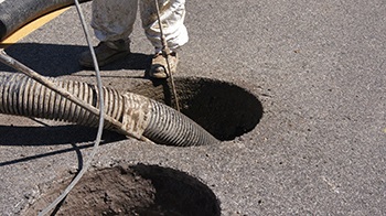 Close up of cleaning out pothole looking for utilities - Mureau Rd (June 2013)