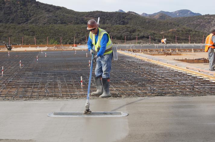 Crew smoothing out the concrete