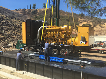 The new emergence generator for the pump station being hoisted into position